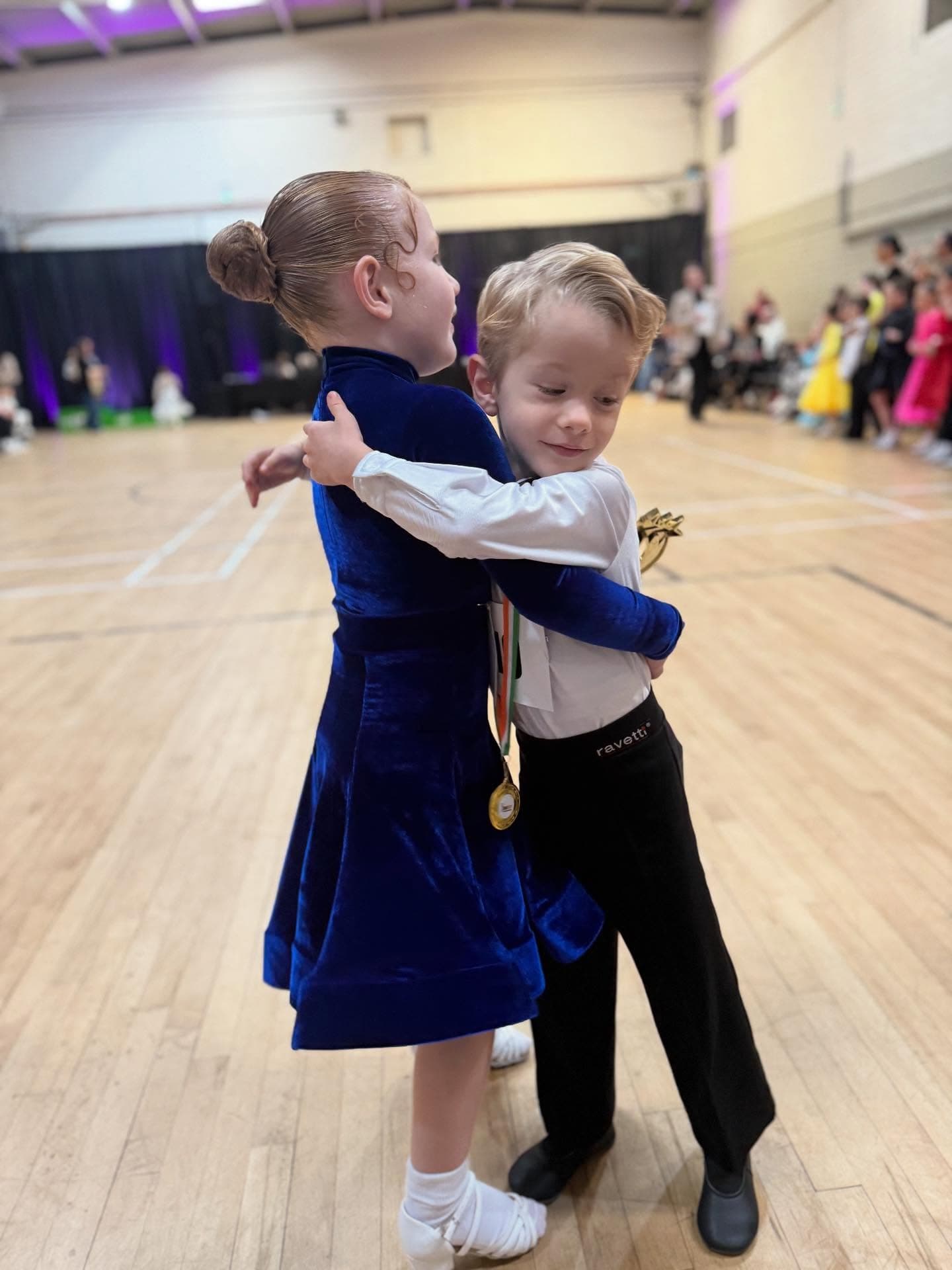 Young dancers hugging at competition