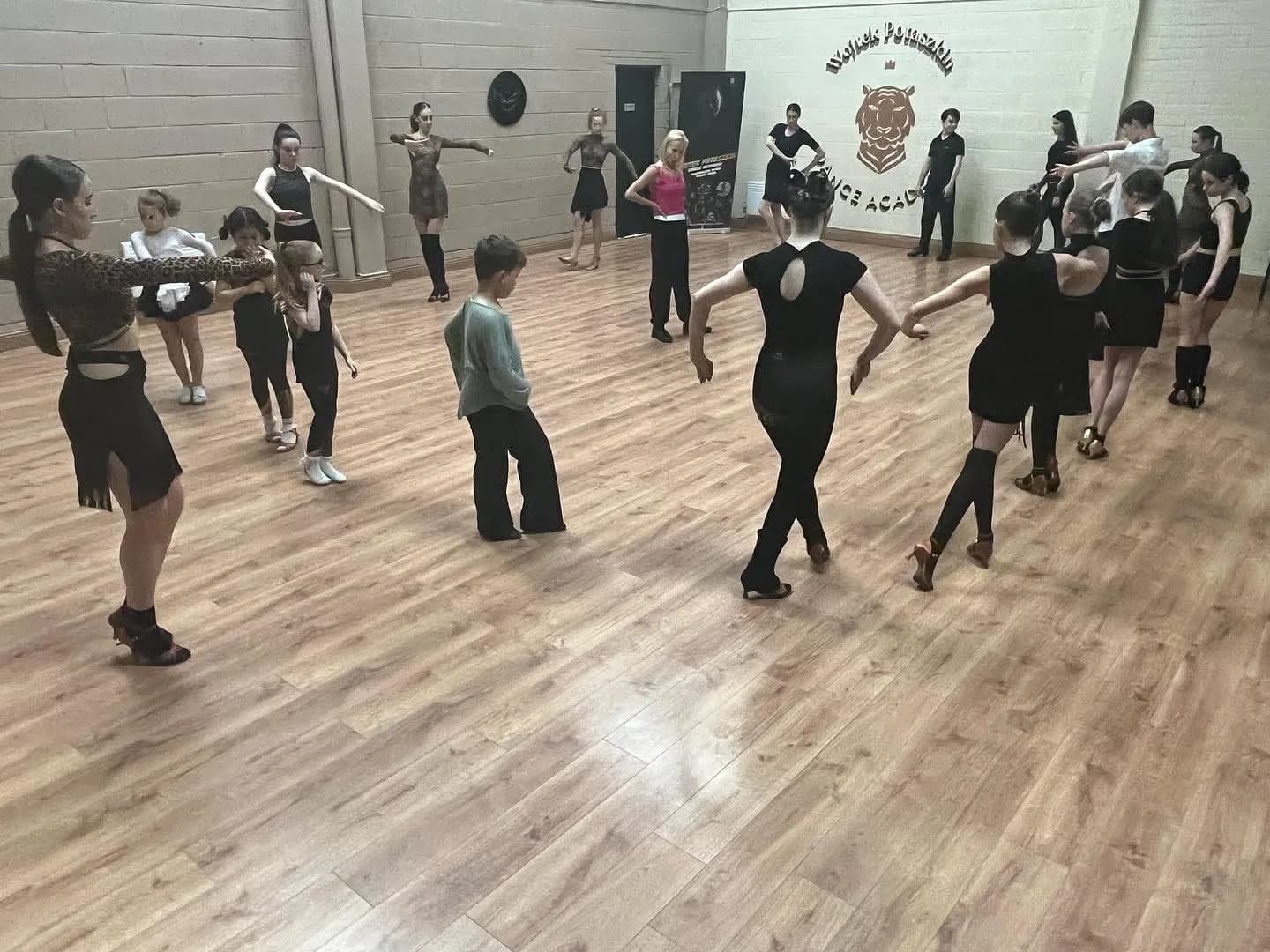 Children and teen ballroom class in studio