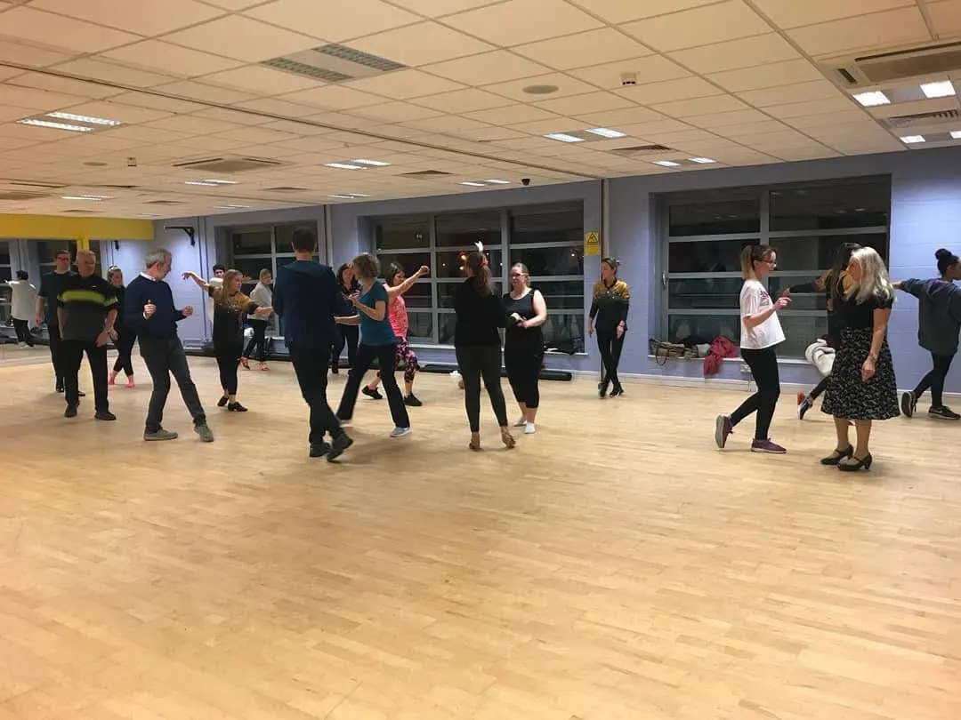 Adults learning partner dance in a beginner class